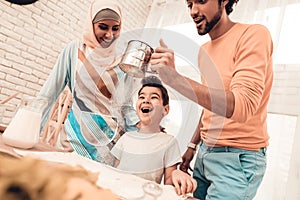 Happy Arabian Family Cooking Food in Kitchen.