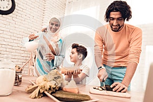 Happy Arabian Family Cooking Food in Kitchen