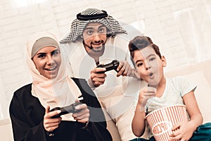 Happy Arabian Family Playing on Console at Home