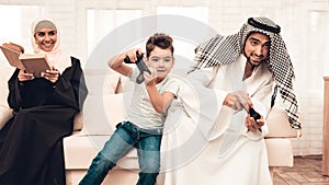 Happy Arabian Family Playing on Console at Home