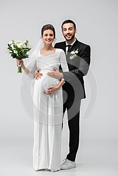 Happy arabian groom hugging pregnant bride