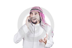 Happy Arabian man talking on cellphone