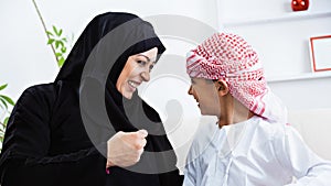 Happy Arabic child at home with his mother