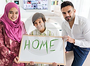 Happy Arabic Muslim family at modern home