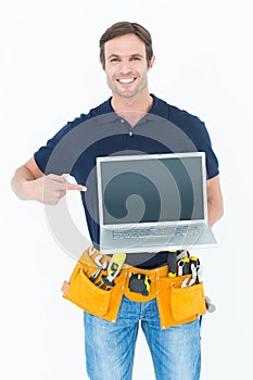 Happy architect pointing at laptop