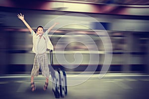 Happy Asain boy jumping, suitcase,