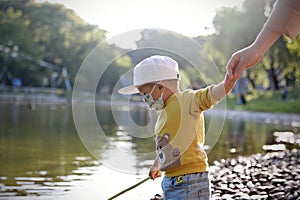 Happy Asia Chinese little boy toddler child play by lake holding string net catch fish carefree childhood parent-child game