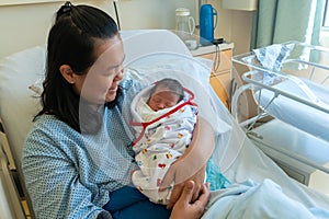 Happy Asia Chinese Mother holding her newborn child