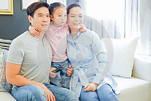 happy Asia family on sofa in living room