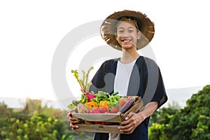 Happy Asia farmer smiling while hold various of vegetable product