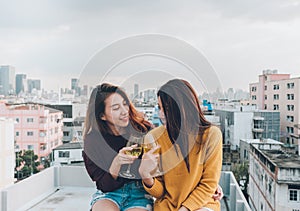 Happy asia girl friends enjoy laughing and cheerful sparkling wine glass at rooftop party,Holiday celebration festive,teeage