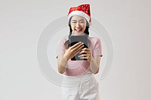 Happy asia girl in pink turtleneck using tablet