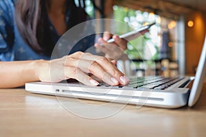 Happy Asia woman doing shopping online and use laptop shopping