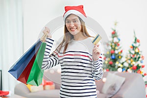 Happy Asia woman use credit card buy Christmas gift in shopping