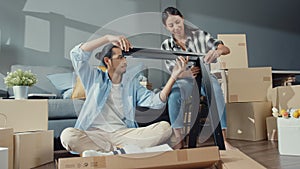 Happy asia young attractive couple man and woman help each other unpacking box and assemble furniture decorate house build table