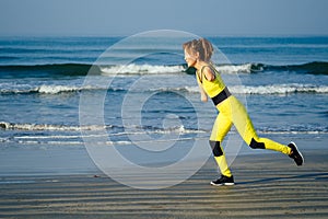 Happy asian armless woman warming up before swimming at the tropical beach