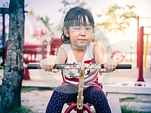 Happy asian baby child playing on playground