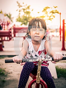 Happy asian baby child playing on playground