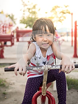 Happy asian baby child playing on playground