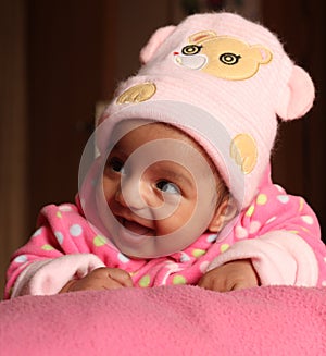 Happy asian baby girl in pink winter cap