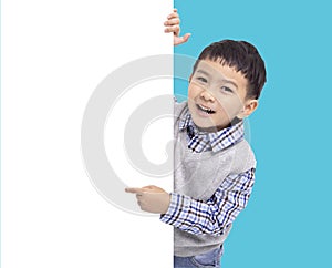Happy Asian boy holding and pointing white empty banner