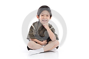 Happy asian boy in kimono sitting