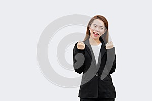 Happy asian business woman arms up in black suit isolated on white color background