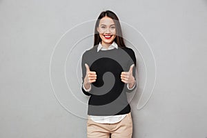 Happy asian business woman in business clothes showing thumbs up