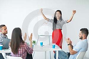 Happy asian business woman celebrating success after presentation