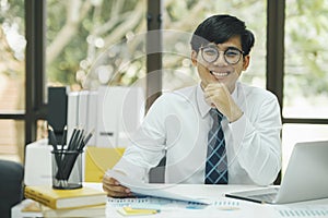 Happy asian businessman about investment market data analysis.