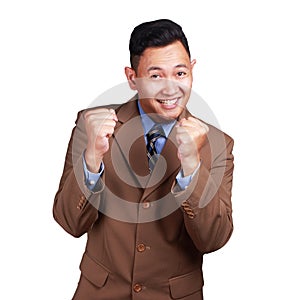 Happy Asian businessman smiling and shows winning gesture