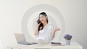 Happy Asian businesswoman having a good conversation over the phone. isolated white background