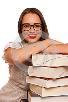 Happy asian caucasian girl lerning in study woth lots of books o