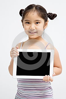 Happy Asian child holding tablet computer