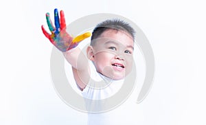 Happy asian childhood kid smile on education art he show hand with water color or finger paint on hands