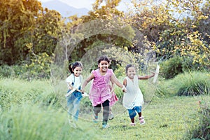 Happy asian children run and play with toy paper airplane