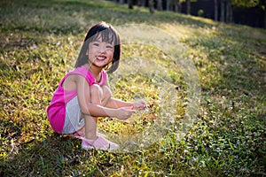 Happy Asian Chinese Little Girl Picking Wild Flowers