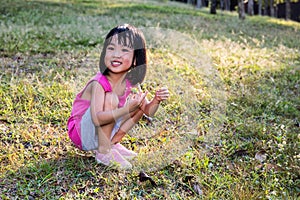 Happy Asian Chinese Little Girl Picking Wild Flowers