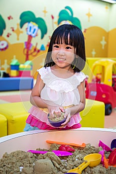 Happy Asian Chinese Little Girl Playing Kinetic Sand Indoor