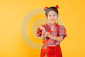 Happy Asian Chinese little girl smile wearing red cheongsam qipao holding silk lanterns