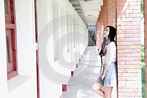 Happy Asian Chinese pretty girl wear student suit in school
