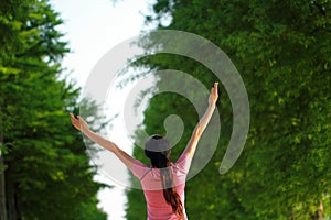 Happy Asian Chinese woman embrace nature and sun