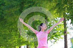 Happy Asian Chinese woman embrace nature and sun