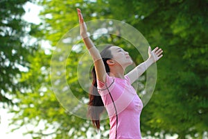 Happy Asian Chinese woman embrace nature and sun