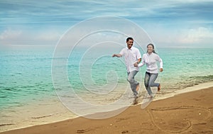 Happy asian couple at beach