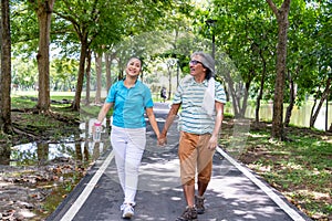 They are happy Asian couple.They give a big hug together after Jogging in park.