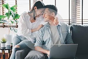 happy Asian couple having a good time at home