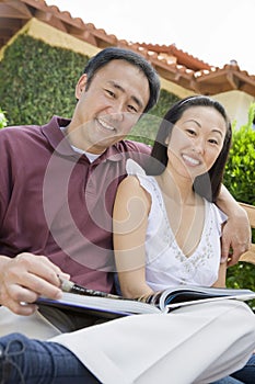 Happy Asian Couple With Novel