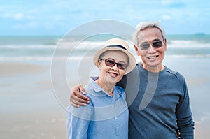 Happy asian couple senior eldery retirement resting at beach honeymoon