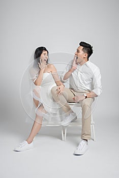 Happy Asian couple sitting on the chair